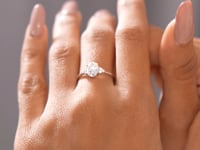 Oval Cut Diamond Gold Ring with Side Stones